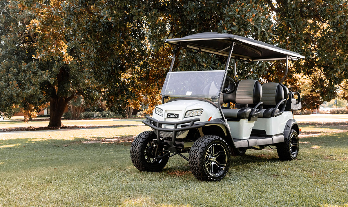 Club car cart in front of trees